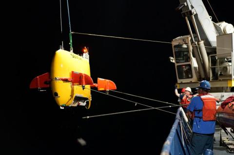 Sentry a yellow robot gets lowered into the ocean from a ship